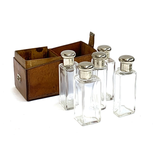 102 - A leather cased set of five spirit flasks, the case 13cm high