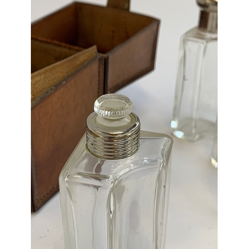 102 - A leather cased set of five spirit flasks, the case 13cm high