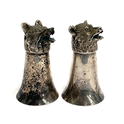 99 - Two plated stirrup cups, of flared plain beaker form, with realistically cast snarling fox and bear ... 