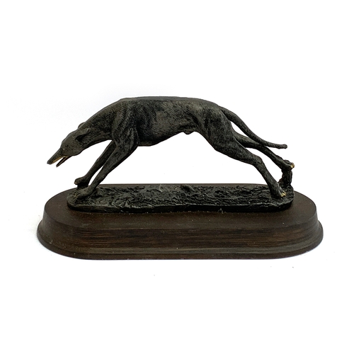 140A - A resin figure of a coursing greyhound, the plinth 32cm long