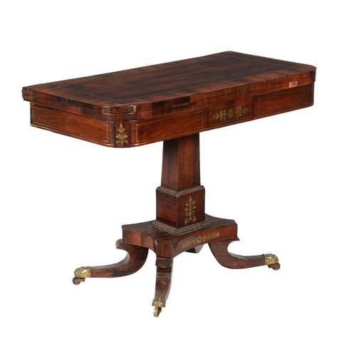 603 - A George IV rosewood and brass inlaid card table, c.1825, the folding top enclosing a baize playing ... 