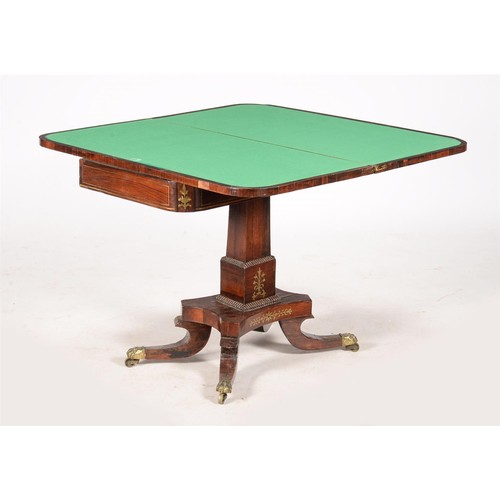 603 - A George IV rosewood and brass inlaid card table, c.1825, the folding top enclosing a baize playing ... 