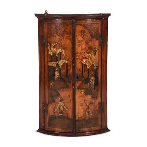 625 - A black japanned bowfront hanging corner cabinet, 18th century, painted in gilt with pavilions and f... 