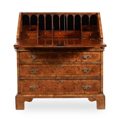 570 - An early 18th century and later walnut bureau, the fall enclosing a fitted interior with drawers and... 