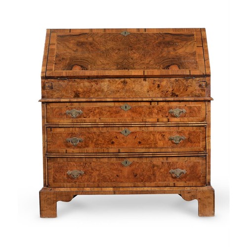 570 - An early 18th century and later walnut bureau, the fall enclosing a fitted interior with drawers and... 