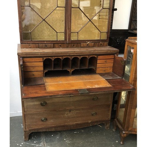 933 - A Regency mahogany astragal glazed secretaire bookcase with fitted interior, over a further three dr... 