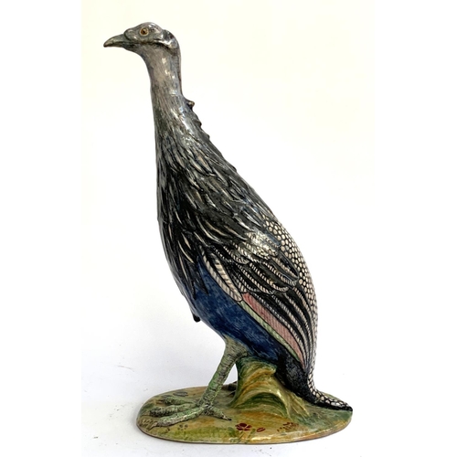 62 - An Italian majolica figure of a bird, marked FLO (base repaired), 48cmH