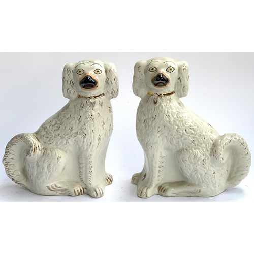 79 - A pair of Staffordshire dogs, highlighted in gilt, 32cmH