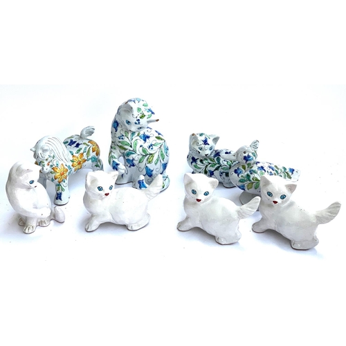 81 - Four glazed ceramic Italian animals with floral pattern, together with four plain ceramic cat figuri... 