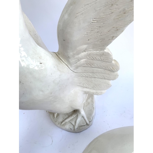 82 - An Italian white glazed ceramic duck, marked 'Flo' to base, 41.5cmH; together with one other