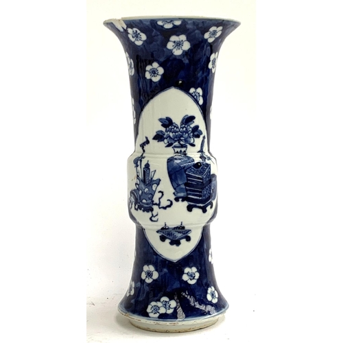 123 - A blue and white Chinese sleeve vase decorated with precious object panels, and prunus ground, four ... 