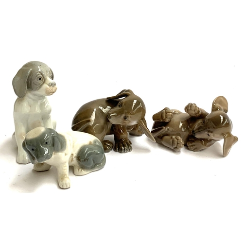 125 - Two Royal Copenhagen puppies, 1407 and 1408; together with two other puppy figurines (4)