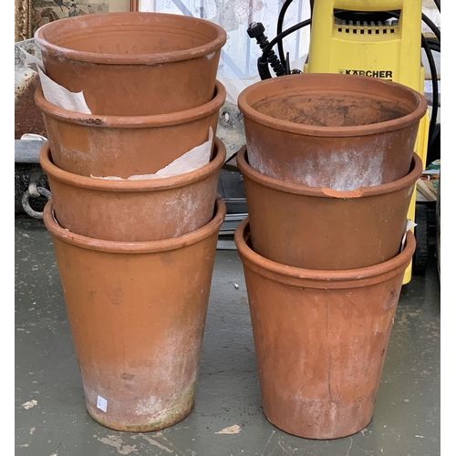 936 - A set of seven terracotta plant pots, each approx. 24cmD