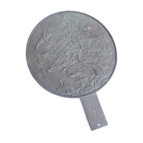 281 - A Japanese bronze kagami mirror decorated with a scene of a crane and tortoise, 40.5cmL