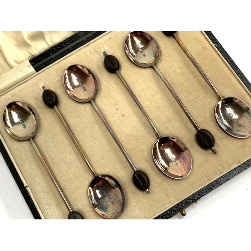 25 - A cased set of six George V silver and guilloche enamel bean terminal coffee spoons, William Sucklin... 