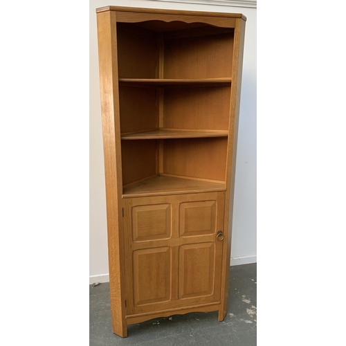 923 - A Reynolds of Ludlow blond oak standing corner cupboard, three shelves over panelled door, stamped t... 