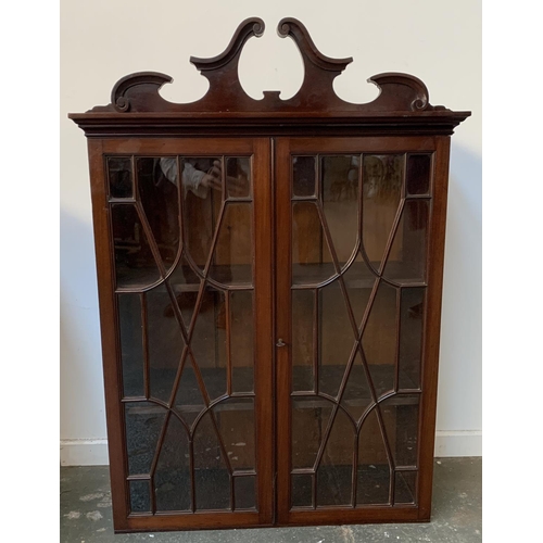 925 - A 20th century mahogany glazed bookcase on a chest of four graduating drawers and bracket feet, 73cm... 