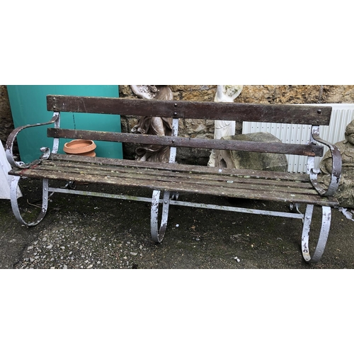 947 - An iron garden bench with slatted wooden seat, approx 175cmW