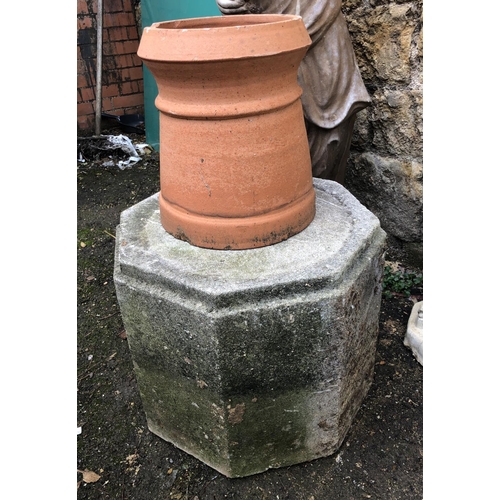 949 - An octagonal composite stone plinth, 49cmW x 39cmH, together with a terracotta chimney pot