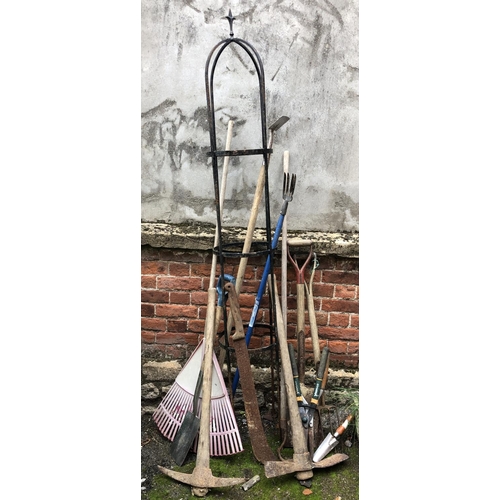 966 - A wrought iron garden rose trellis, 205cmH, together with a selection of garden tools