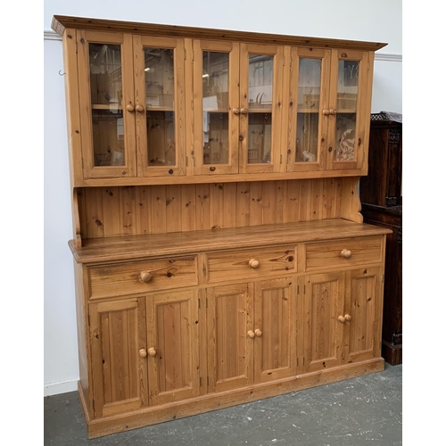 930 - A pine kitchen dresser, six door glazed top, over a base of three drawers and a further six cupboard... 