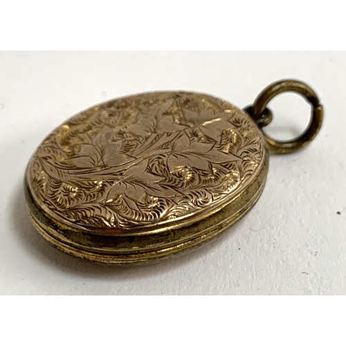 5A - A gold back and front locket with engraved foliate design, approx. 2.5cmL