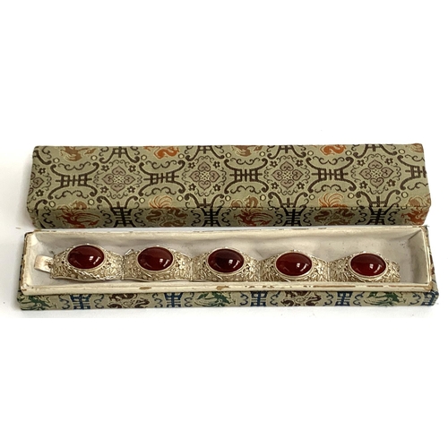 5 - An early 20th century Chinese export silver filigree bracelet set with carnelian cabochons, with saf... 