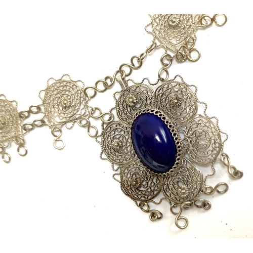 6 - A quantity of white metal items, mainly filigree, to include necklace set with a blue cabochon, 43cm... 