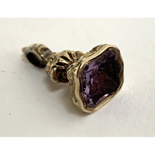 8 - A very small Georgian gold cased fob seal, set with a foiled amethyst shield shape intaglio depictin... 