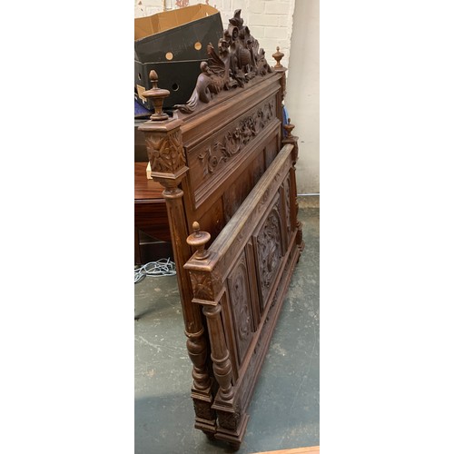 922a - A carved hardwood double bed, the headboard crested with dragons