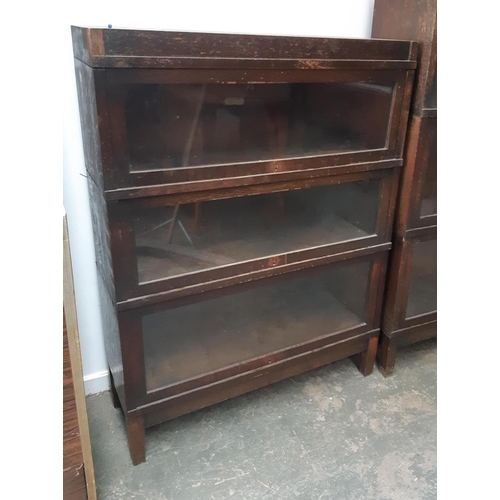 921 - An oak Globe-Wernicke three section bookcase, each section with plaque, 88x29x116cm