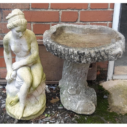 957 - A composite stone figure of a seated nude, 60cmH together with a composite stone garden birdbath, 44... 