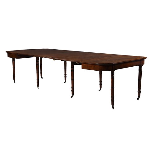 633 - A Regency mahogany and parcel ebonised extending dining table, c.1820, with three additional leaf in... 