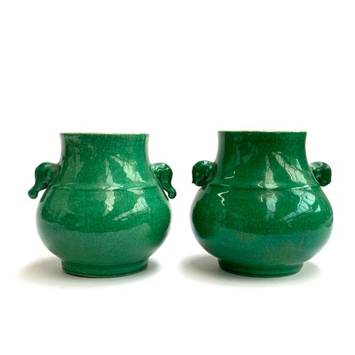 52 - A pair of Chinese green crackle glaze twin handled vases, of short bulbous form with central central... 