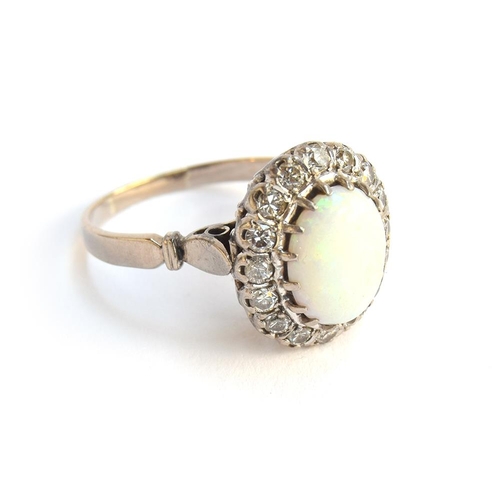 41 - A diamond and opal cabochon ring mounted in white metal, size W, approx. 7g