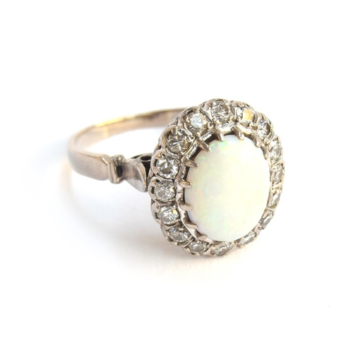 41 - A diamond and opal cabochon ring mounted in white metal, size W, approx. 7g