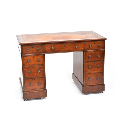 653 - A Victorian mahogany pedestal desk, of neat proportions, the gilt tooled skiver over a traditional a... 