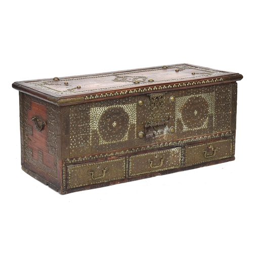 556 - A studded teak and brass bound Zanzibar chest, late 19th century, the hinged top enclosing storage a... 