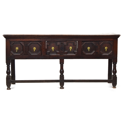 567 - A Charles II oak dresser base, three plank top, over three frieze drawers with geometric mouldings, ... 