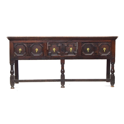 567 - A Charles II oak dresser base, three plank top, over three frieze drawers with geometric mouldings, ... 