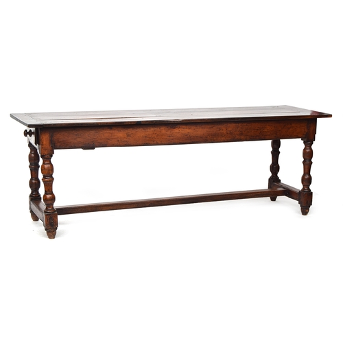 563 - A fruitwood and oak refectory style table, three plank top with cleated ends, single end drawer, on ... 