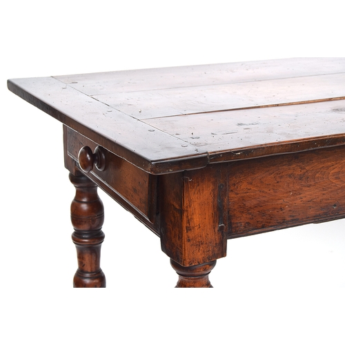 563 - A fruitwood and oak refectory style table, three plank top with cleated ends, single end drawer, on ... 