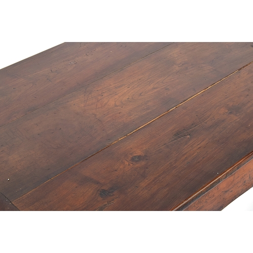 563 - A fruitwood and oak refectory style table, three plank top with cleated ends, single end drawer, on ... 