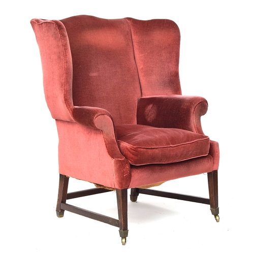 696 - A George III style hipped wingback armchair in the Chippendale taste, upholstered in red velvet, on ... 