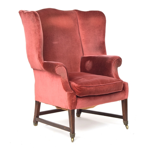 696 - A George III style hipped wingback armchair in the Chippendale taste, upholstered in red velvet, on ... 