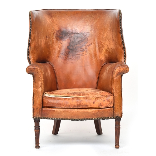 697 - A 19th century leather wingback armchair, curved back, with close-nail leather upholstery on turned ... 