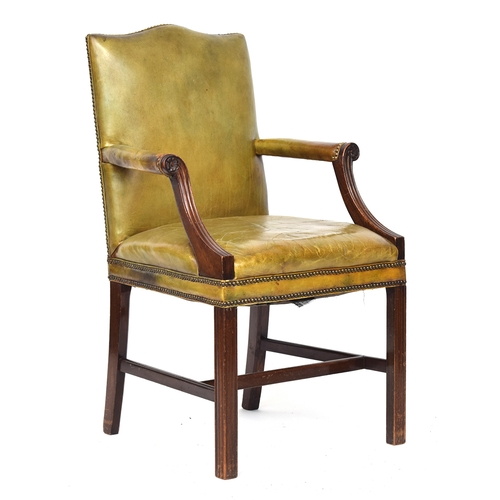 699 - A George III style mahogany Gainsborough armchair, upholstered in close nailed green leather, with s... 