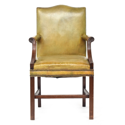 699 - A George III style mahogany Gainsborough armchair, upholstered in close nailed green leather, with s... 