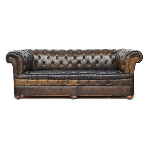 710 - A late 19th century three seater Chesterfield sofa, button upholstered in greenish brown leather, wi... 