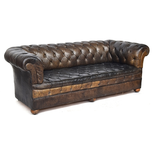 710 - A late 19th century three seater Chesterfield sofa, button upholstered in greenish brown leather, wi... 